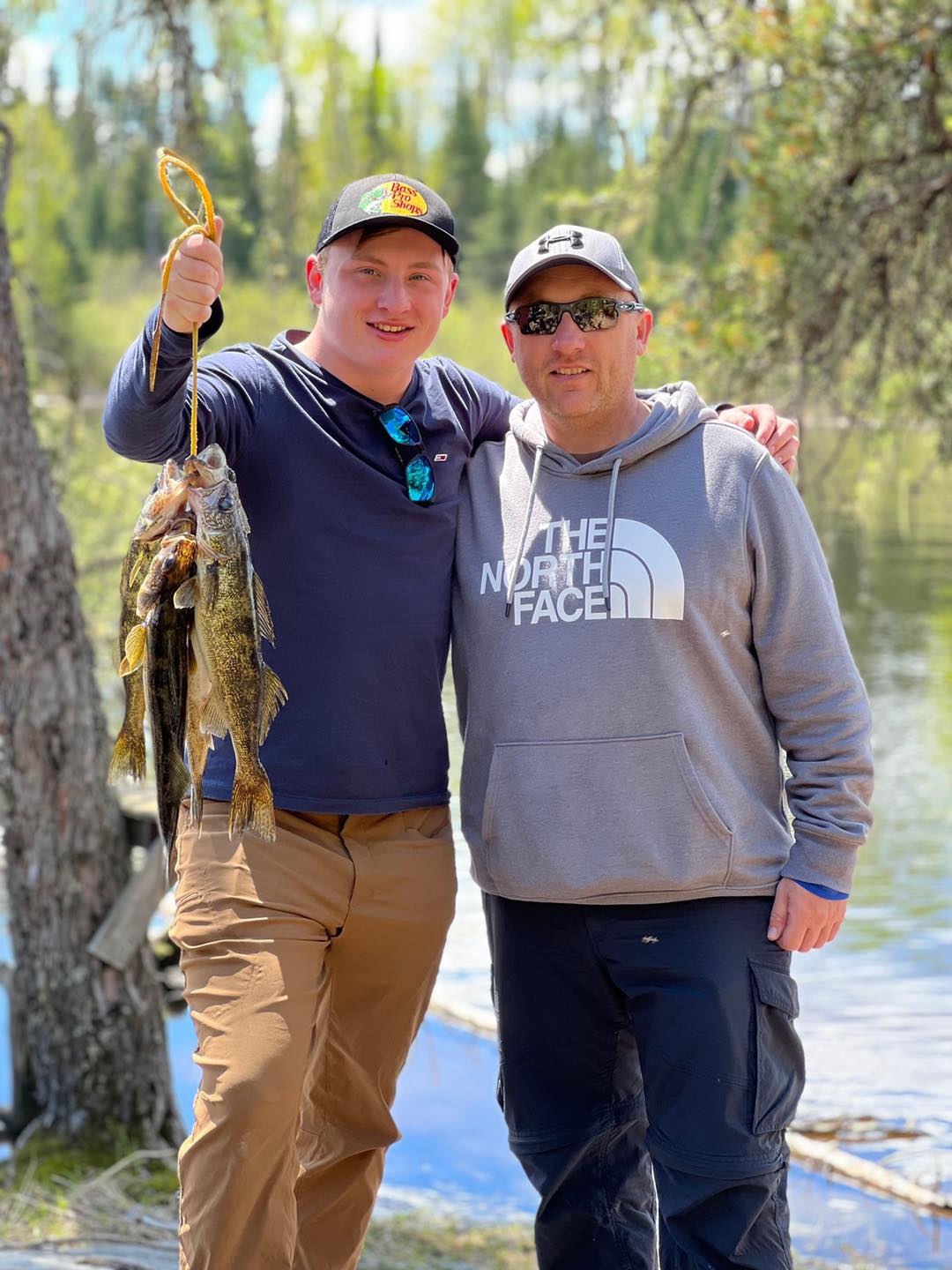 Father and son with a stringer of walleyes
