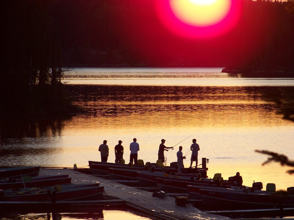 Anglers gathered at the dock at sunset
